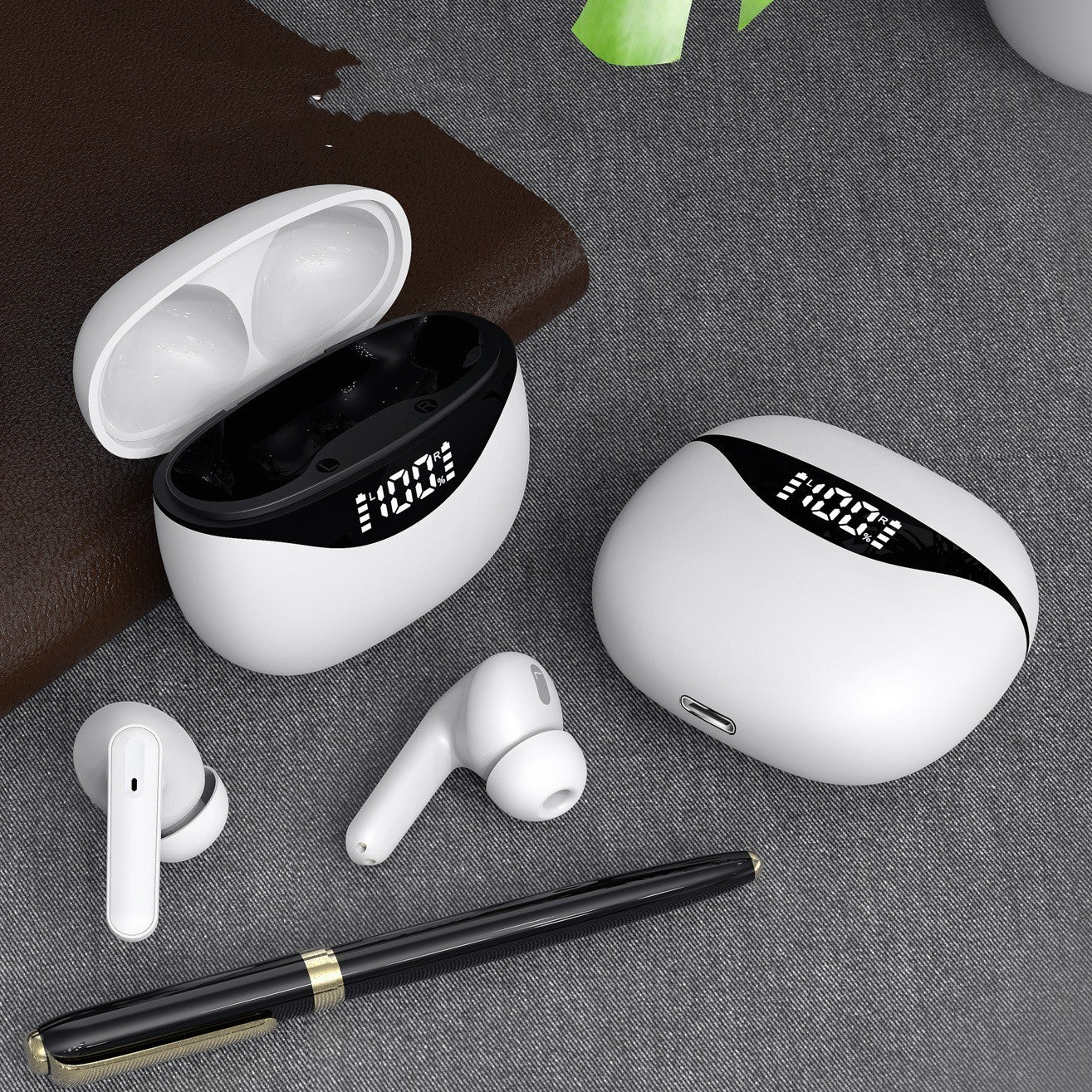 White wireless earbuds with charging case on a gray surface.